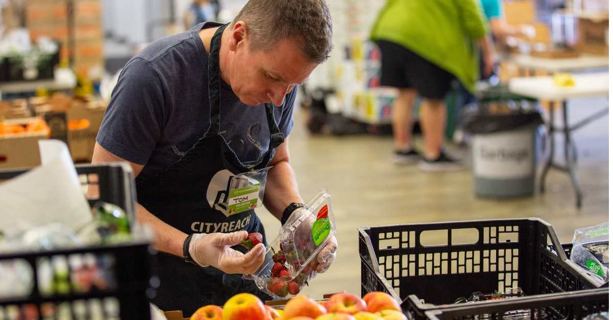 Tom Truchan from Georgia Main, helping to sort strawberries at CityReach Care Society.