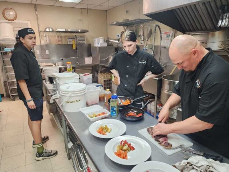 Youth learning culinary skills with recovered food at Dan's Diner