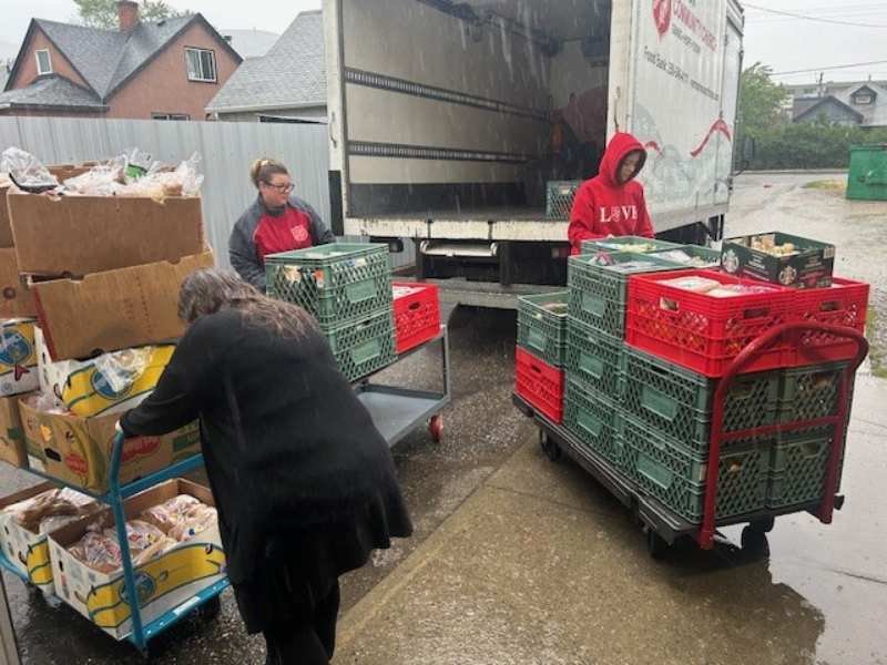 Volunteers loading food donations into a truck.