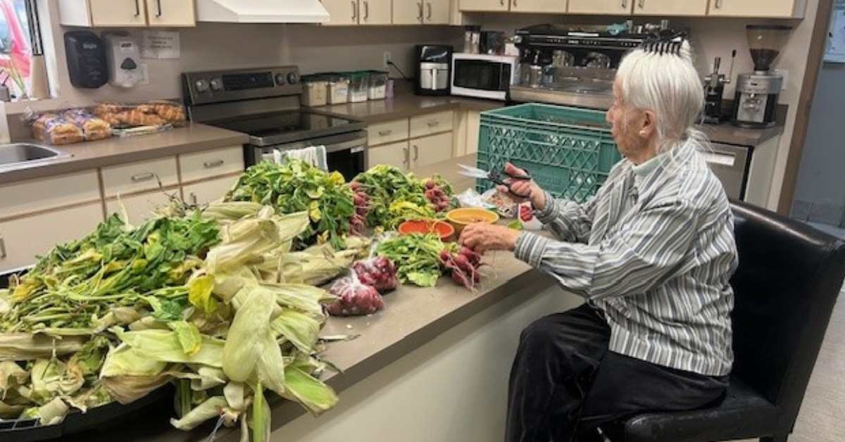 Salvation Army volunteer gives wilted produce a haircut.