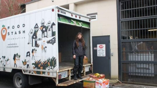 Food Stash volunteer in truck collecting food donations.