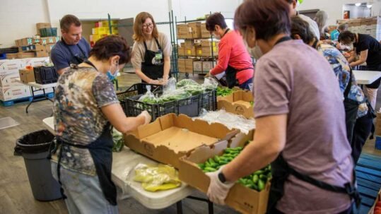 Volunteers packing food donations.