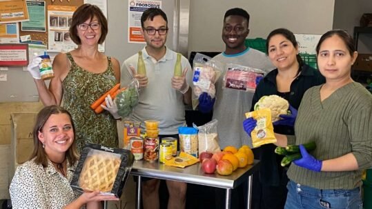 Archway food bank volunteers sorting food donations.